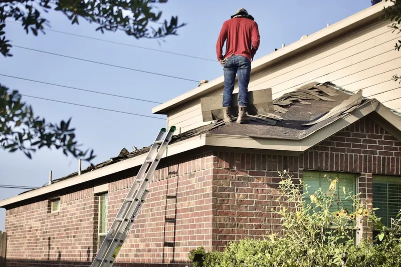Professional roofer working on a residential roof in Ross